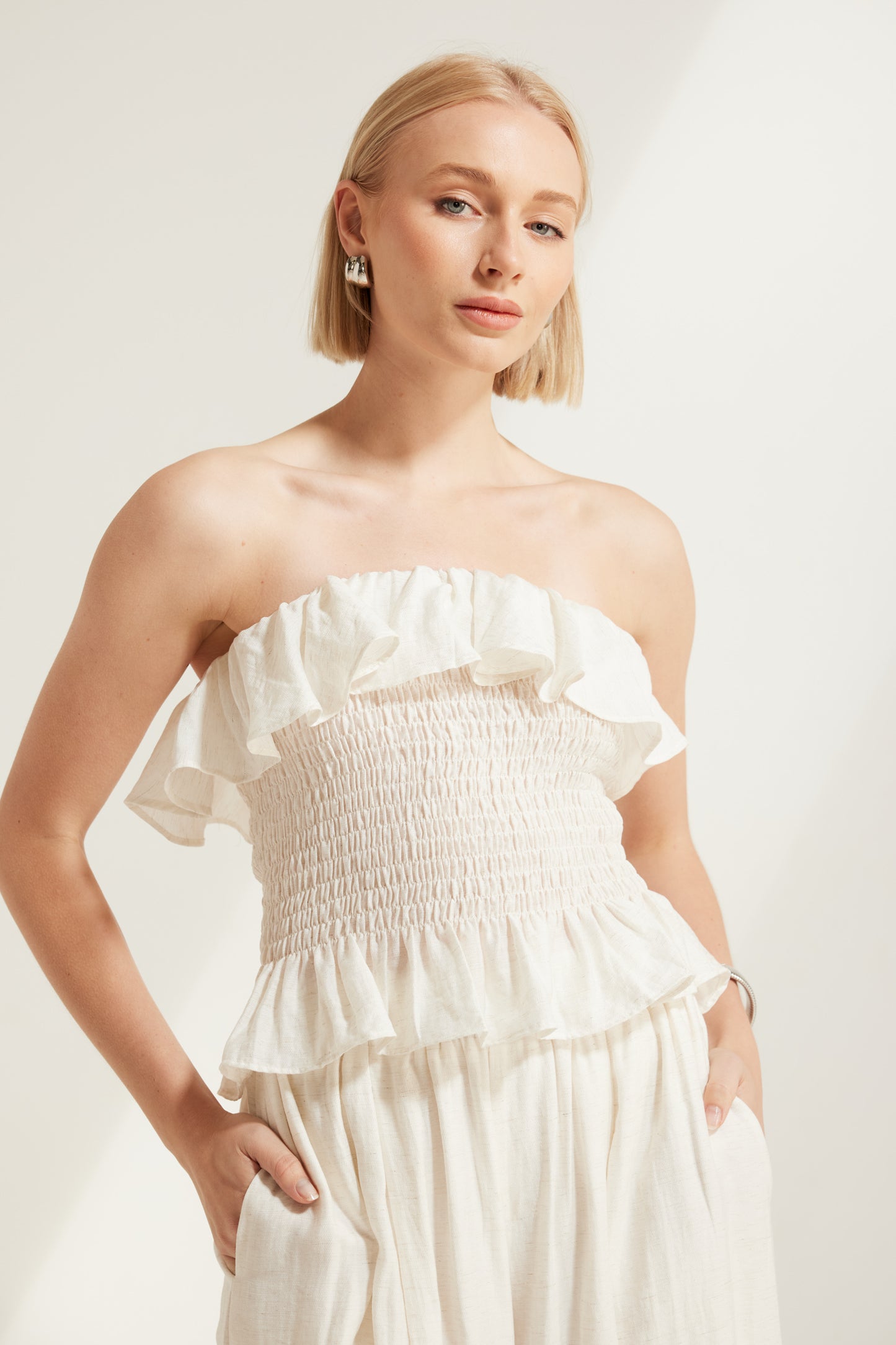 TW4793 Celina Shirred Ruffle Top Natural Ivory. Australian women’s WHOLESALE SLEEVELESS TOPS. Matching set come in Shirred body top and wide leg pant.